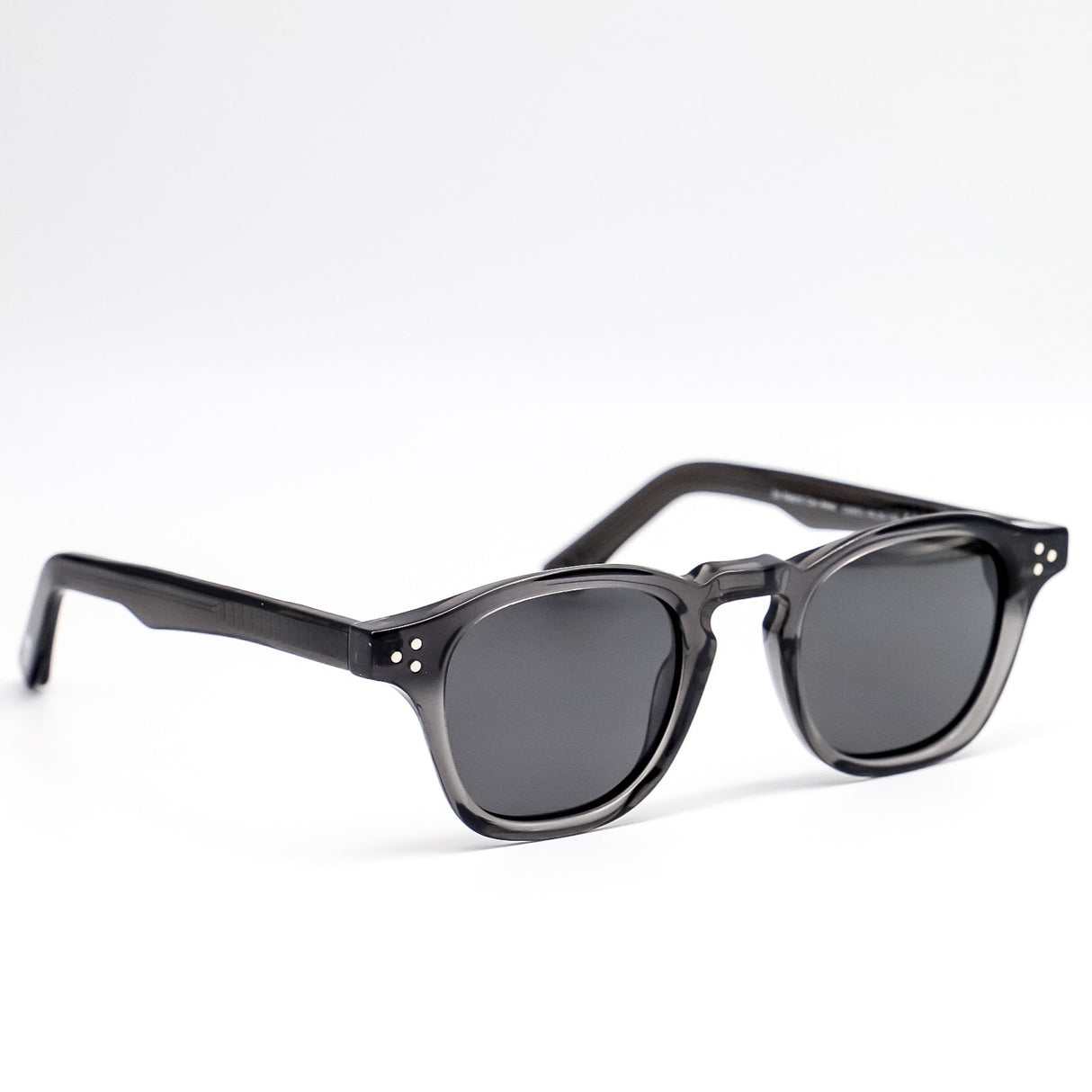 Black sunglasses with dark lenses on a white background