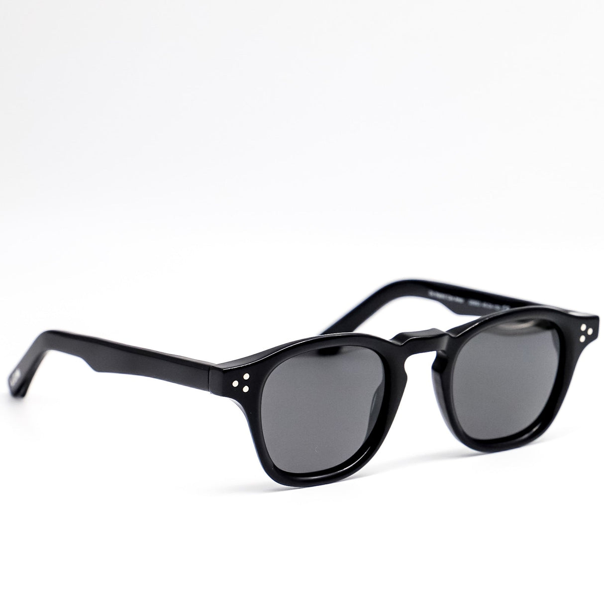 Black sunglasses with dark lenses on a white background